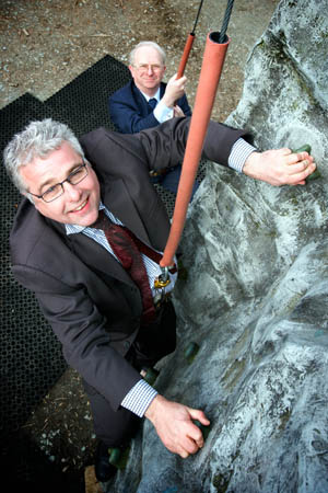 Cumbrias tourism chief, Ian Stephens, (front) watched by commercial members chairman Haydn Spedding, tackling the climbing wall at the Low Wood Watersports Centre. Photo: Steven Barber