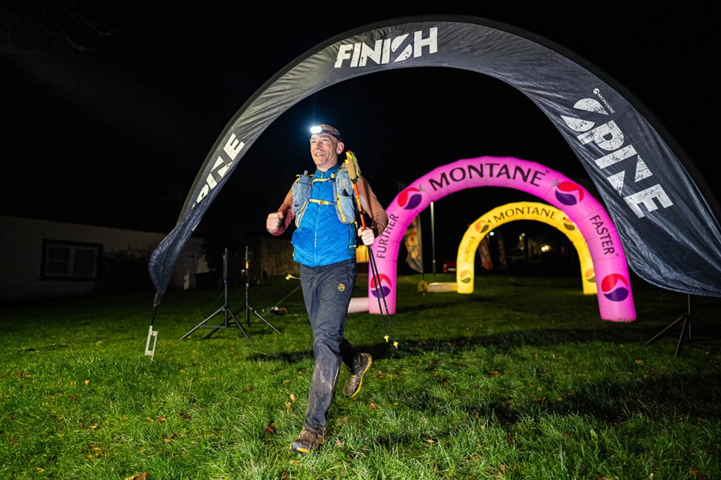 Kim Collison reaches the finish line at Kirk Yetholm. Photo: willbaldlygo/The Spine Race