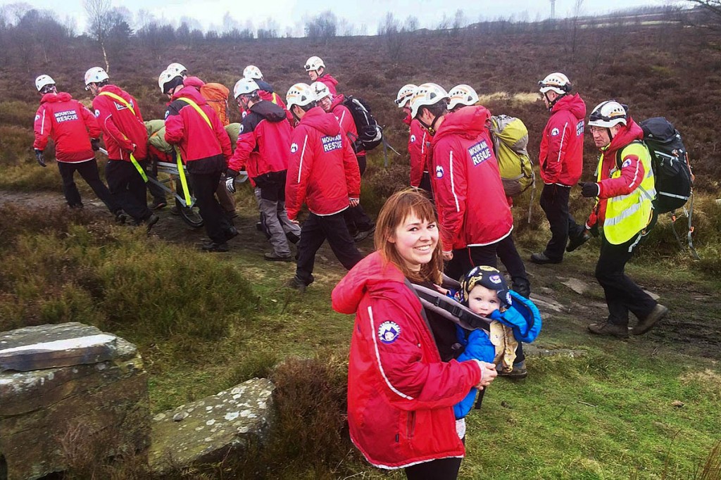 The injured man is stretchered from the moor by rescuers as Sophie Keeler and Jesse look on. Photo: Calder Valley SRT