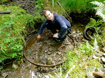 Ranger Fraser MacKechnie with the object at the site of its discovery